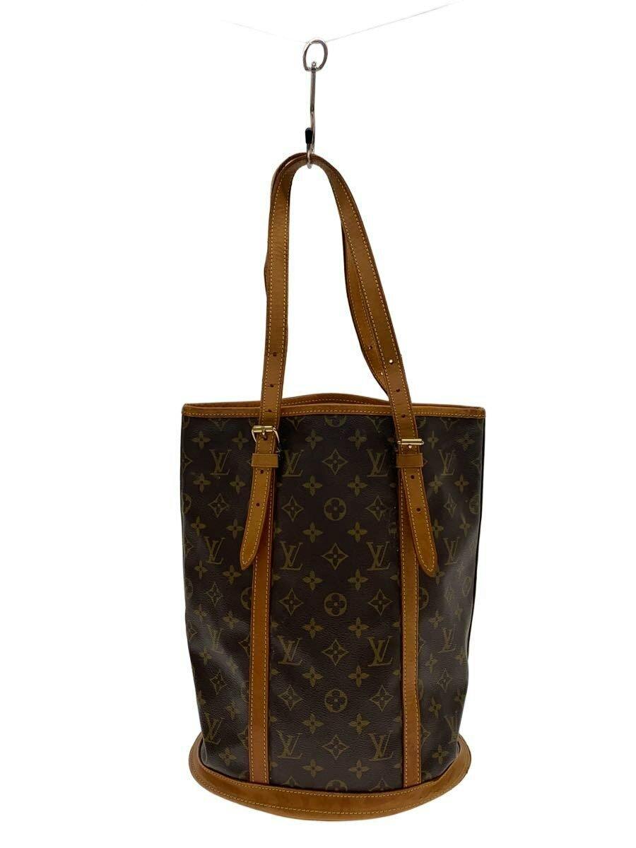 Front view of the Louis Vuitton monogram canvas Bucket GM bag with brown leather trim and shoulder straps.