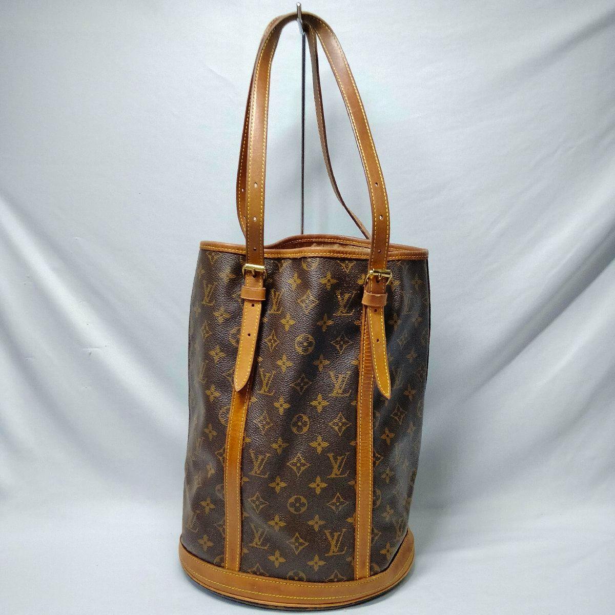 Front view of a Louis Vuitton Monogram Bucket GM tote bag with leather trim and shoulder straps.