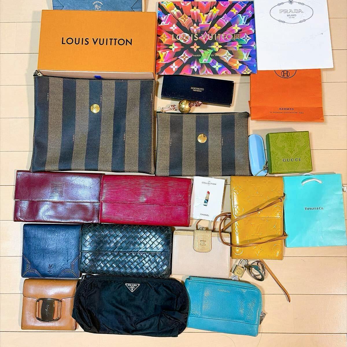 Overhead photo of a bulk set of assorted wallets, pouches, and brand boxes laid out on a floor.