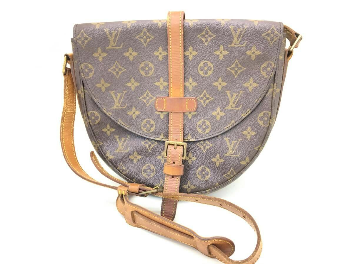 Front view of the LOUIS VUITTON monogram canvas Chantilly GM shoulder bag showing the flap, central leather strap with buckle, and shoulder strap.