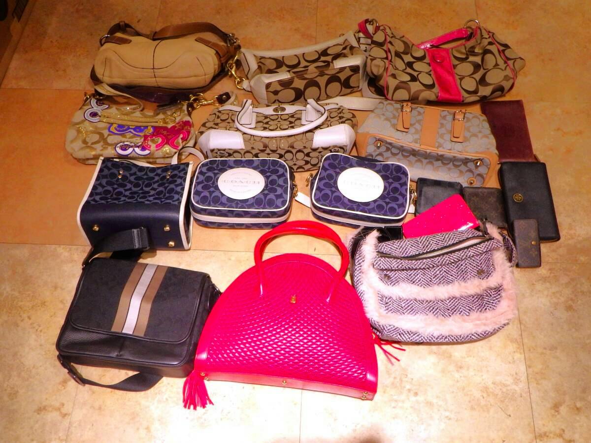 A group of handbags and shoulder bags arranged on a tiled floor photographed together as a lot.