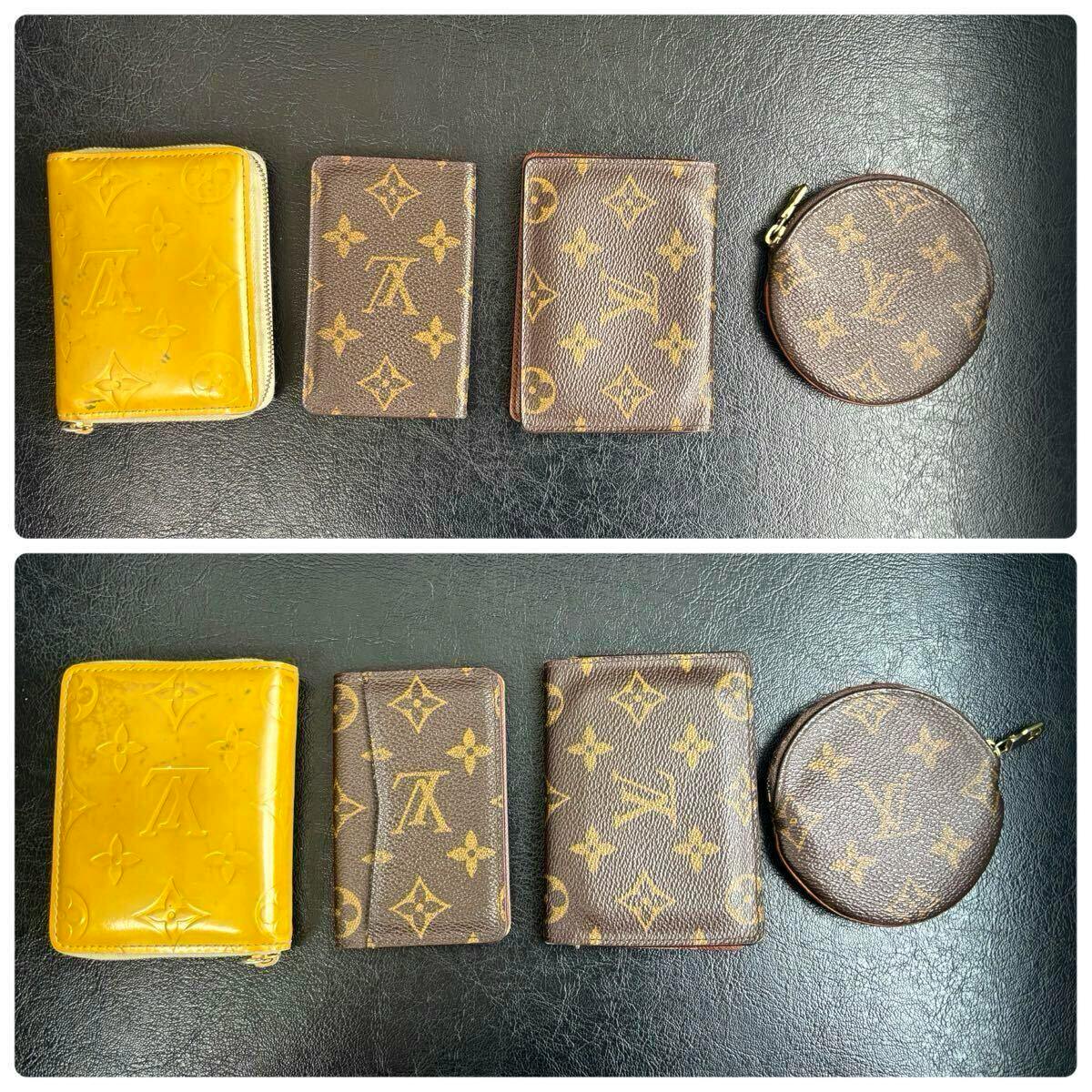 Four Louis Vuitton small cases (wallet, coin case, pass case, and round coin pouch) laid flat on a black surface.