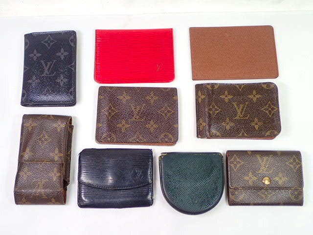 Nine Louis Vuitton small wallets, coin and card cases in monogram, Epi, and Taiga styles arranged on a white background.