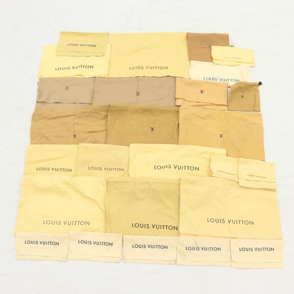 A layout of multiple Louis Vuitton cotton dust/storage bags arranged flat on a surface.