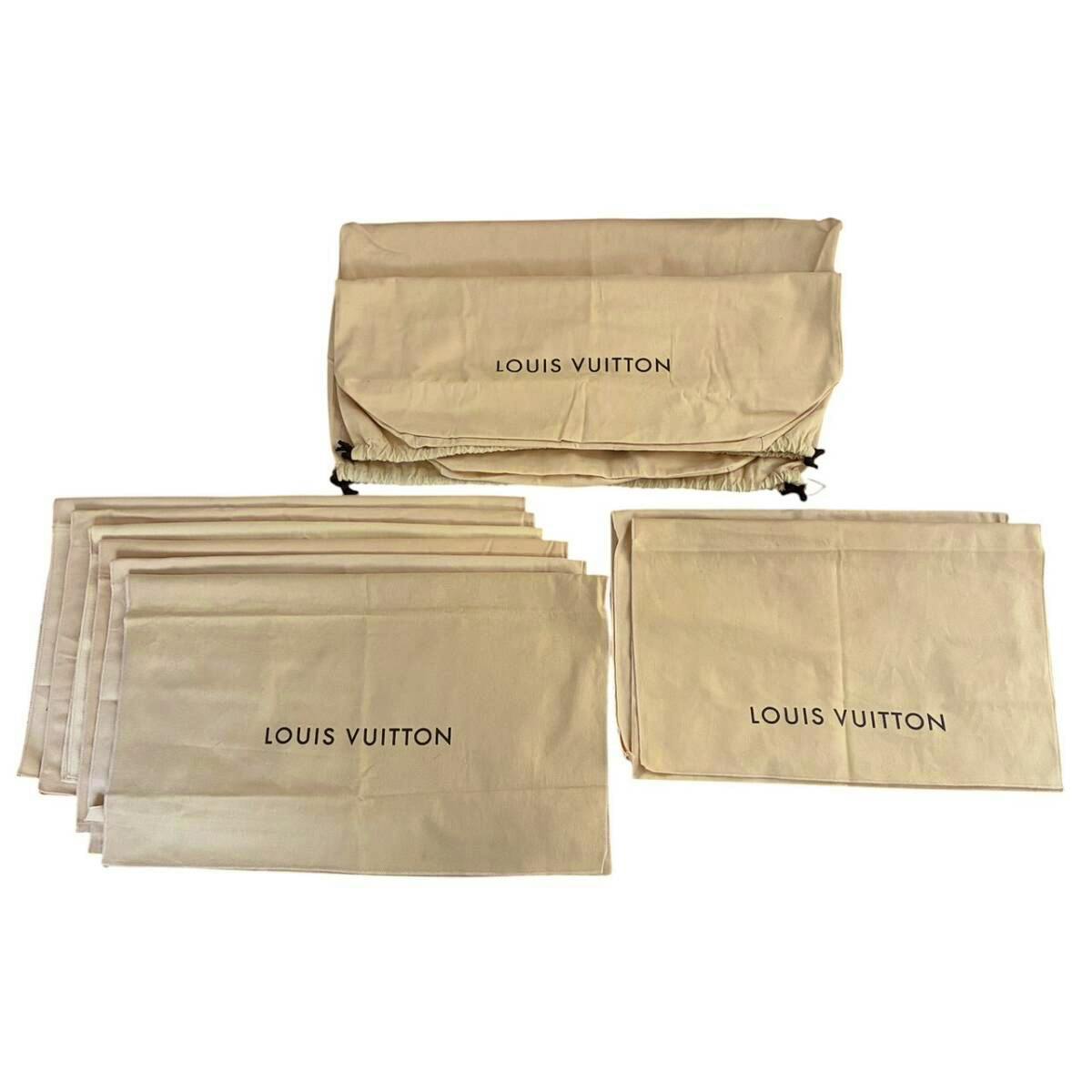 Several beige Louis Vuitton cotton dust bags with 'LOUIS VUITTON' printed, arranged flat.