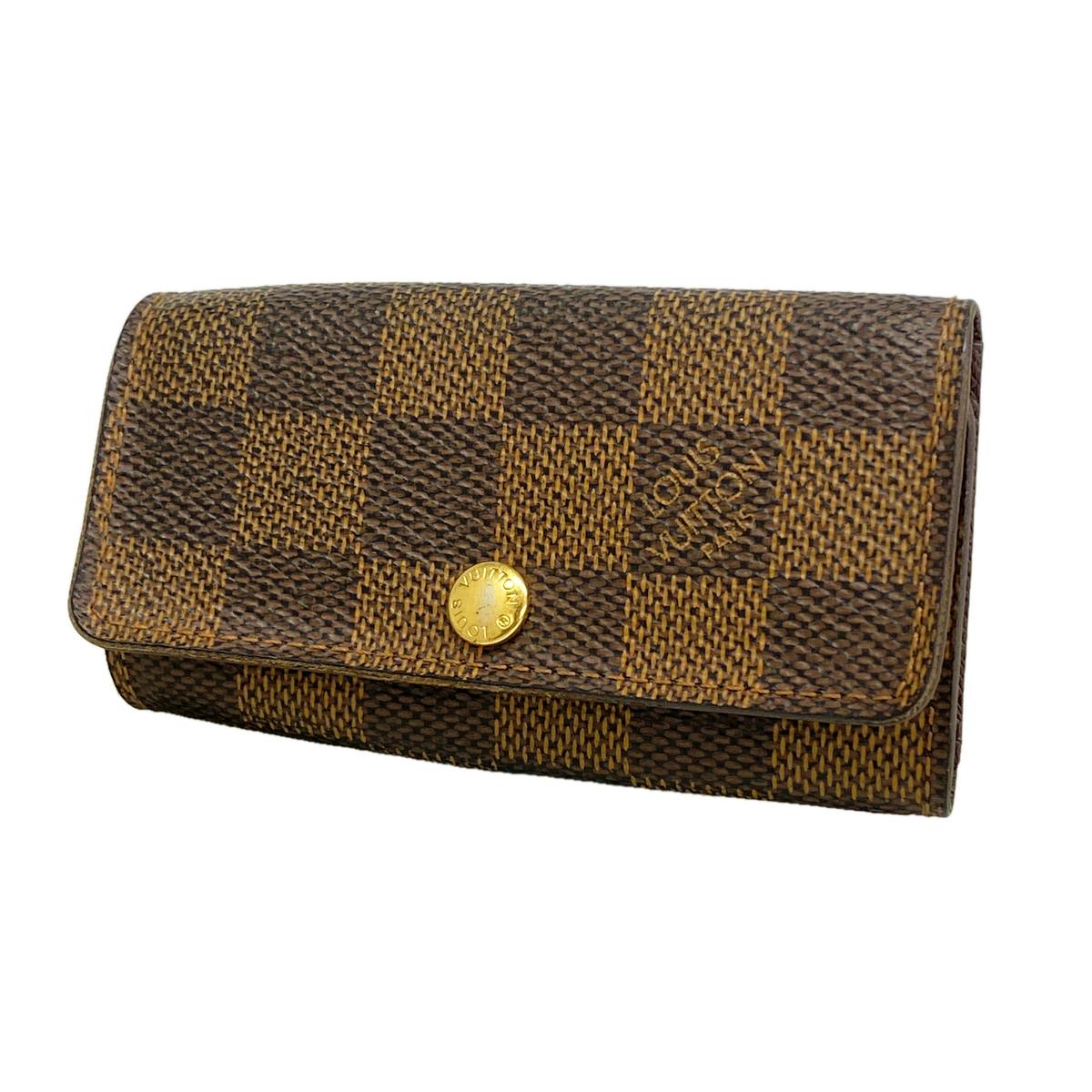 Front view of the Louis Vuitton Damier Ébène Multicles 4 key case (N62631) in brown checker pattern with a gold snap closure.