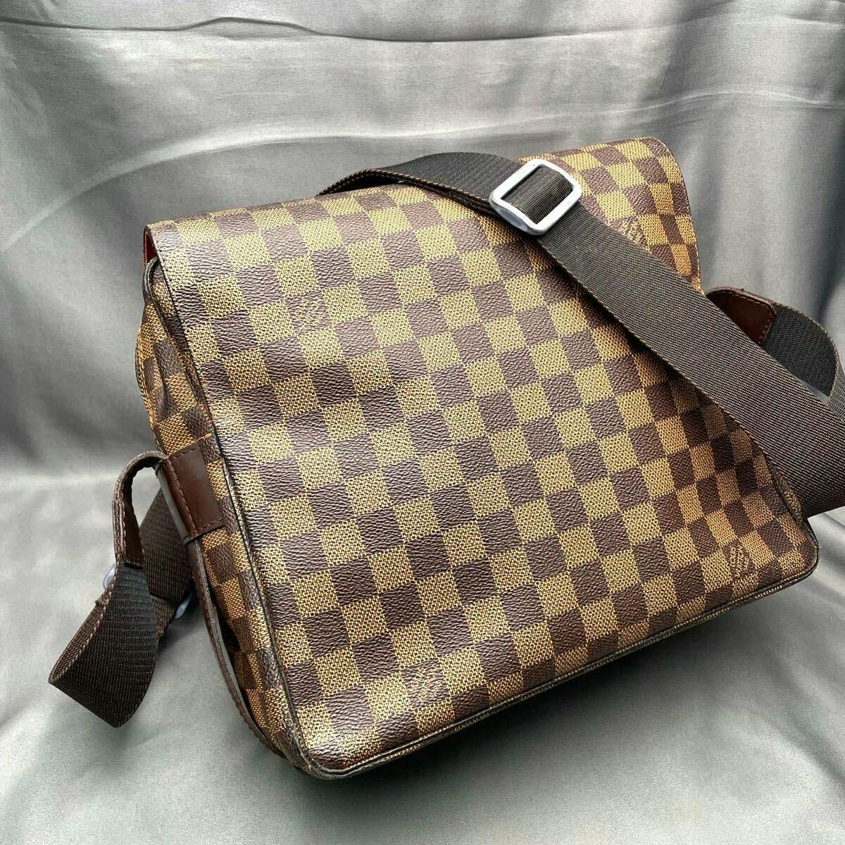 Louis Vuitton Damier Ebene brown checkered shoulder/crossbody bag with a flap and adjustable fabric strap visible.