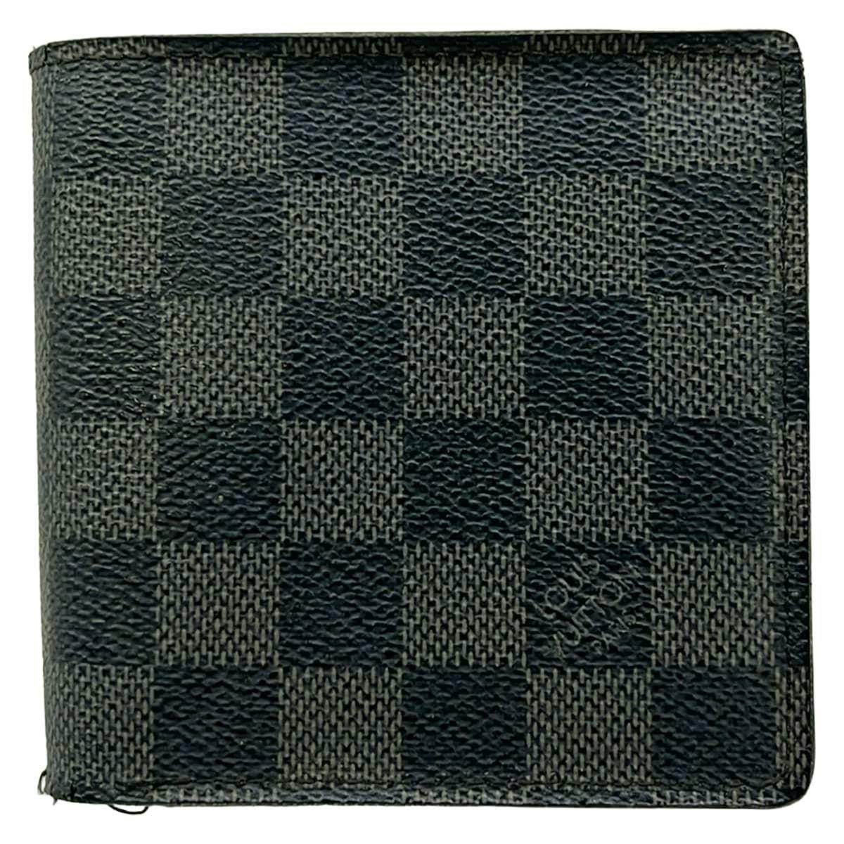 Front exterior of a Louis Vuitton Damier Graphite canvas two-fold wallet showing the checkered pattern.