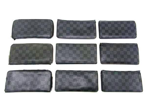 Nine Louis Vuitton wallets in Damier Graphite pattern arranged on a white background.