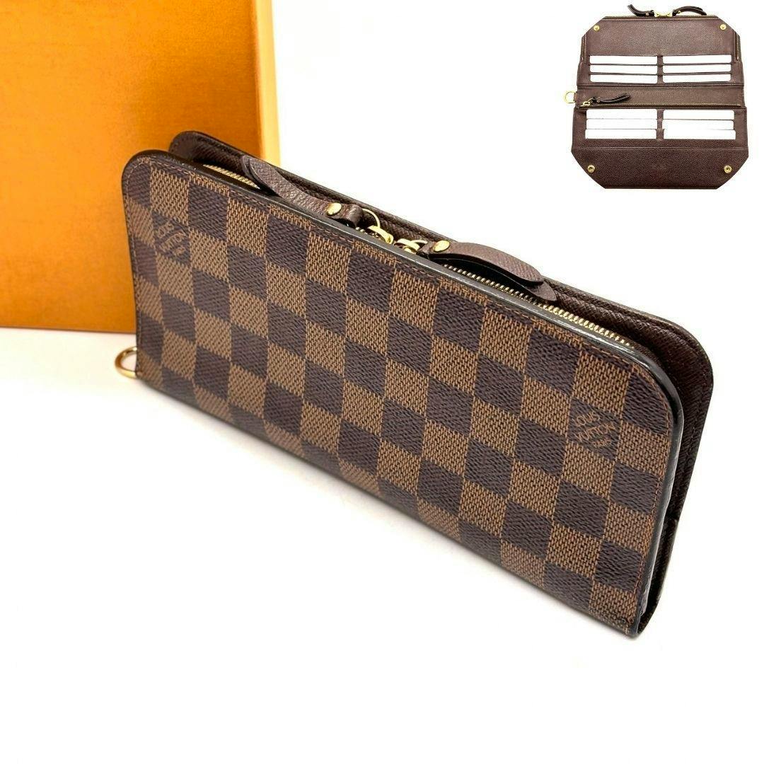 Brown Louis Vuitton Damier long wallet with a gold zipper angled on a white surface with a small inset showing interior card slots.