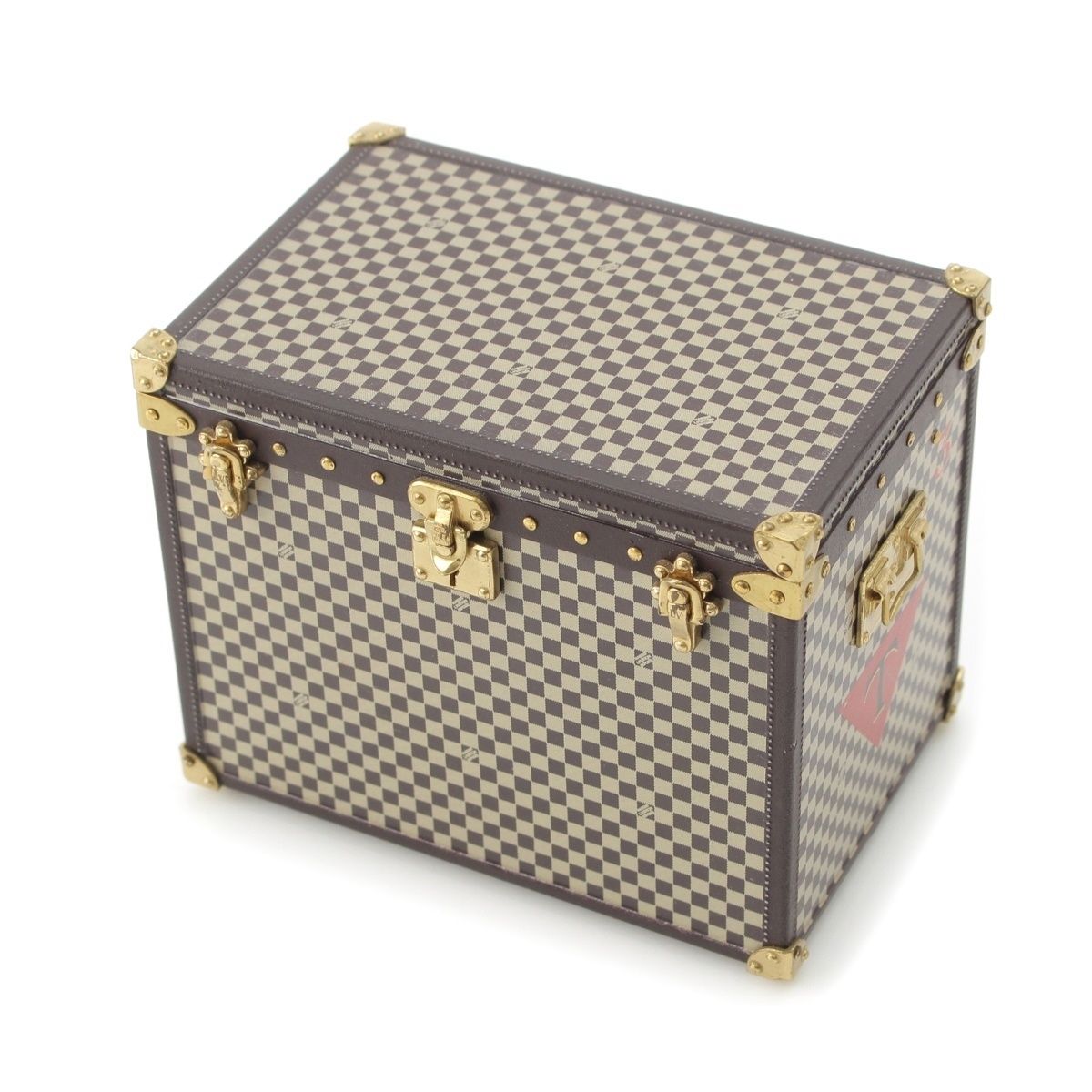 Brown Damier-pattern Louis Vuitton trunk-style paperweight with gold-tone brass hardware on a white background.