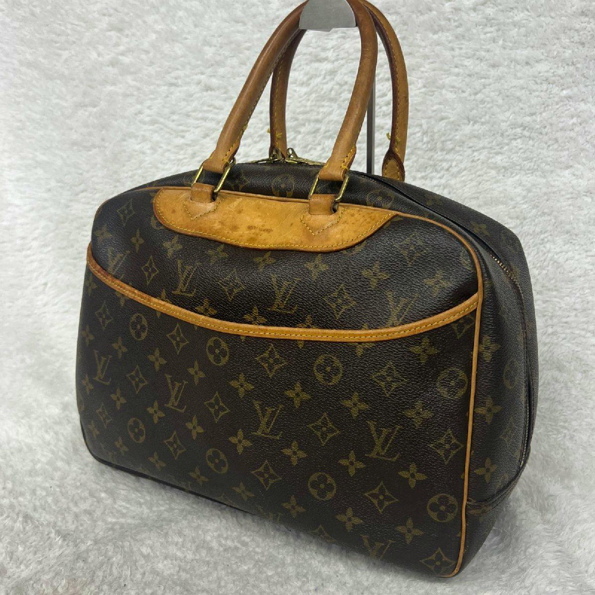 Louis Vuitton brown monogram canvas handbag with leather trim and double handles shown on a white background.