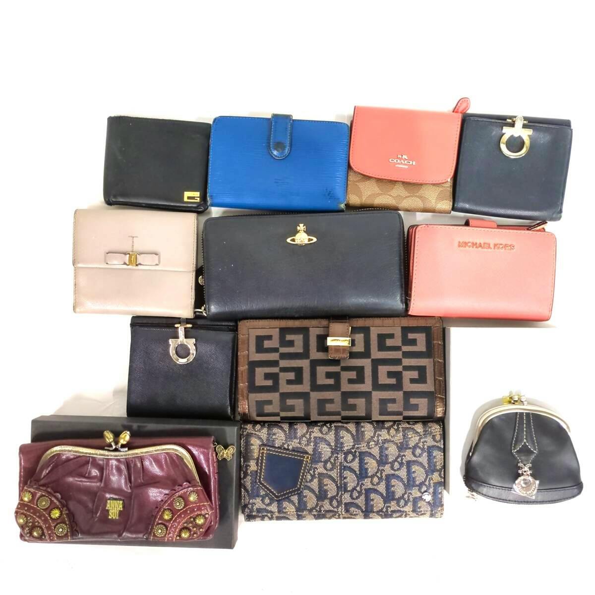 Twelve assorted wallets and small coin purses arranged on a white background.