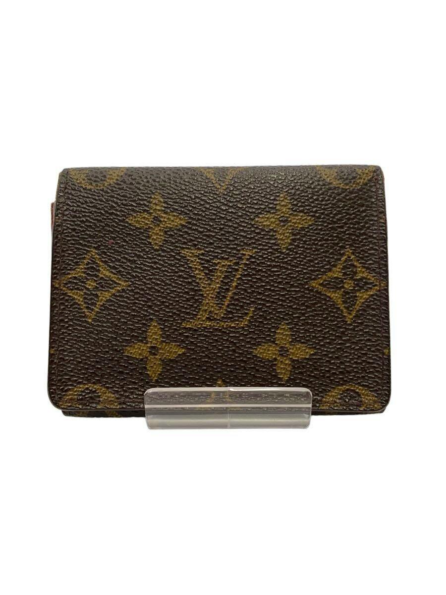 Front exterior of the Louis Vuitton monogram canvas envelope card wallet displayed on a clear stand.