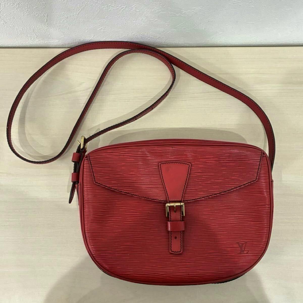 Front view of the castilian red Louis Vuitton Epi shoulder bag with its strap visible.