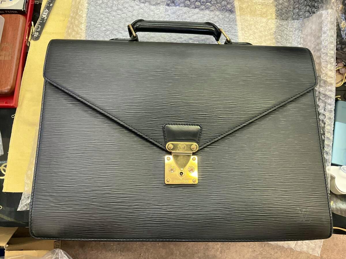Front view of a black Louis Vuitton Epi leather business bag with a top handle and gold-tone clasp.
