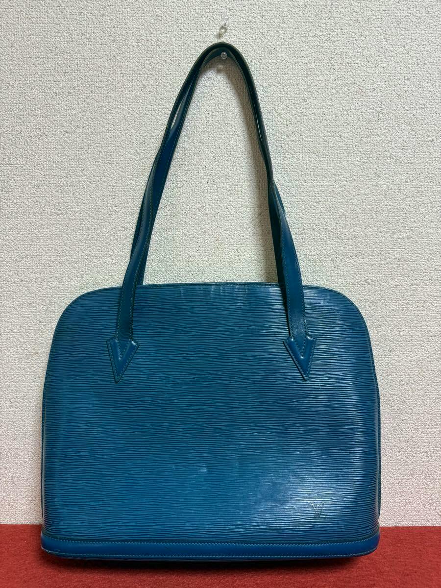 Front view of the Toledo Blue Louis Vuitton Epi leather tote bag showing its textured body and two shoulder straps against a wall.