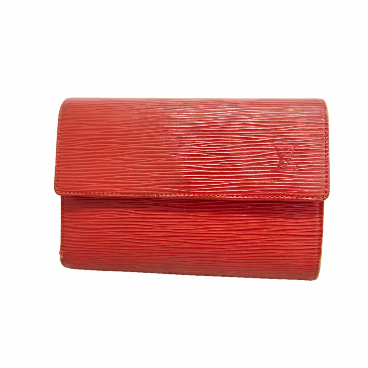 Red Louis Vuitton Epi leather trifold wallet with flap showing an embossed LV logo.