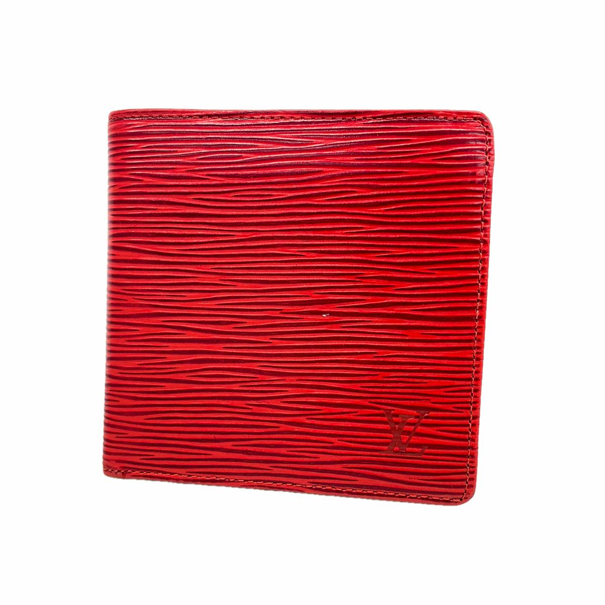 Red Louis Vuitton Epi cow leather wallet showing textured horizontal ridges and an embossed LV logo.