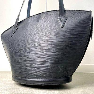 Black Louis Vuitton Epi leather Saint-Jacques tote handbag standing on a floor, showing textured leather and handles.