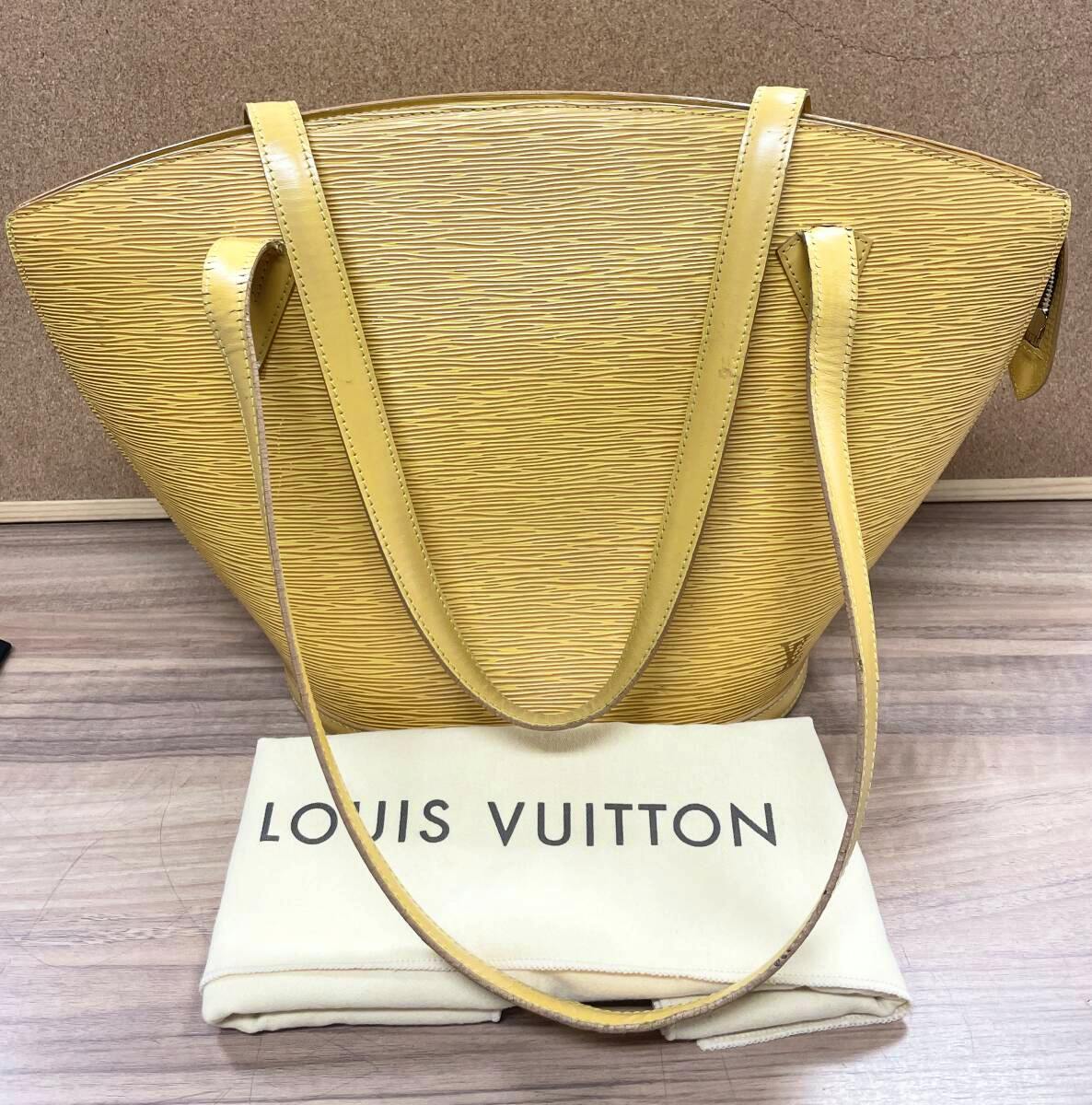 Yellow Louis Vuitton Epi shoulder bag (M52269) shown front with shoulder straps and a folded Louis Vuitton dust bag beneath.