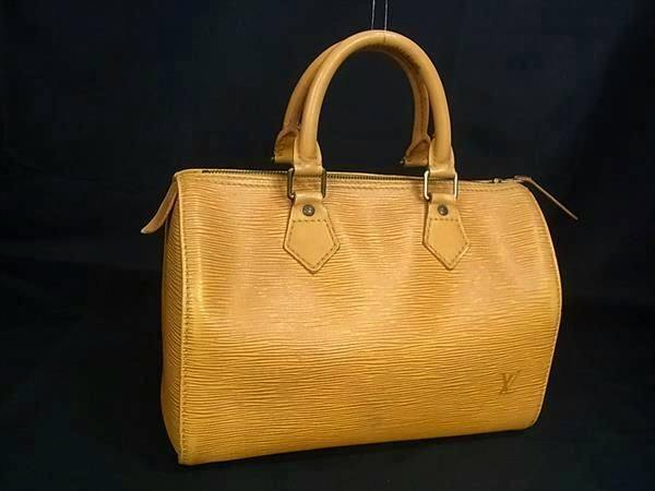 Louis Vuitton Epi Speedy25 mini Boston handbag in Tassili yellow displayed against a black background.
