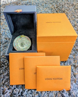 Open Louis Vuitton presentation box showing the Escale table clock inside with outer box and documentation visible.