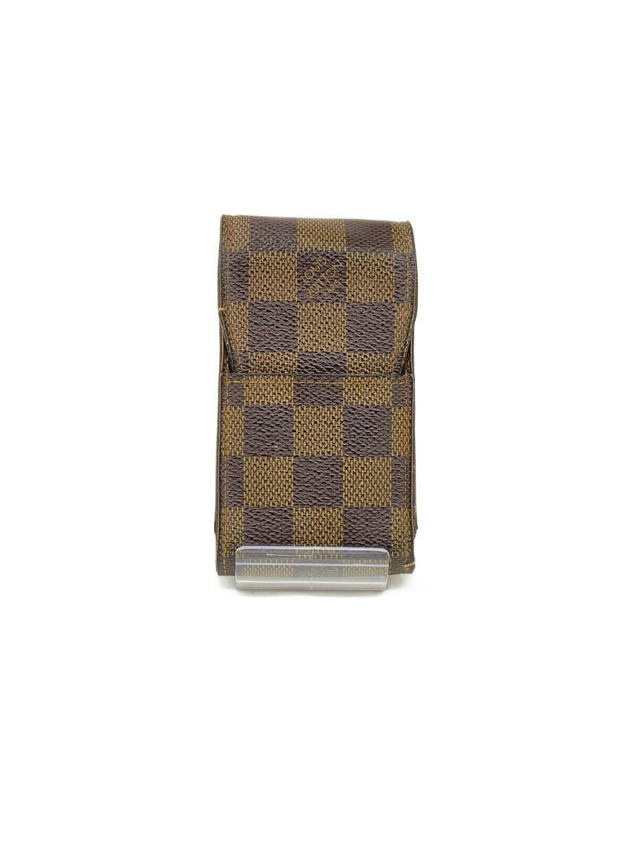 Front view of a brown Damier Ébène patterned Louis Vuitton cigarette case/wallet displayed on a white background.
