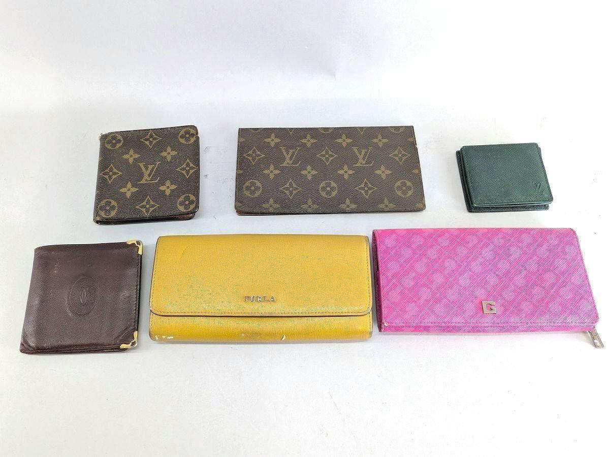 Seven wallets and small purses arranged on a white background, including two Louis Vuitton monogram wallets and a pink long wallet.