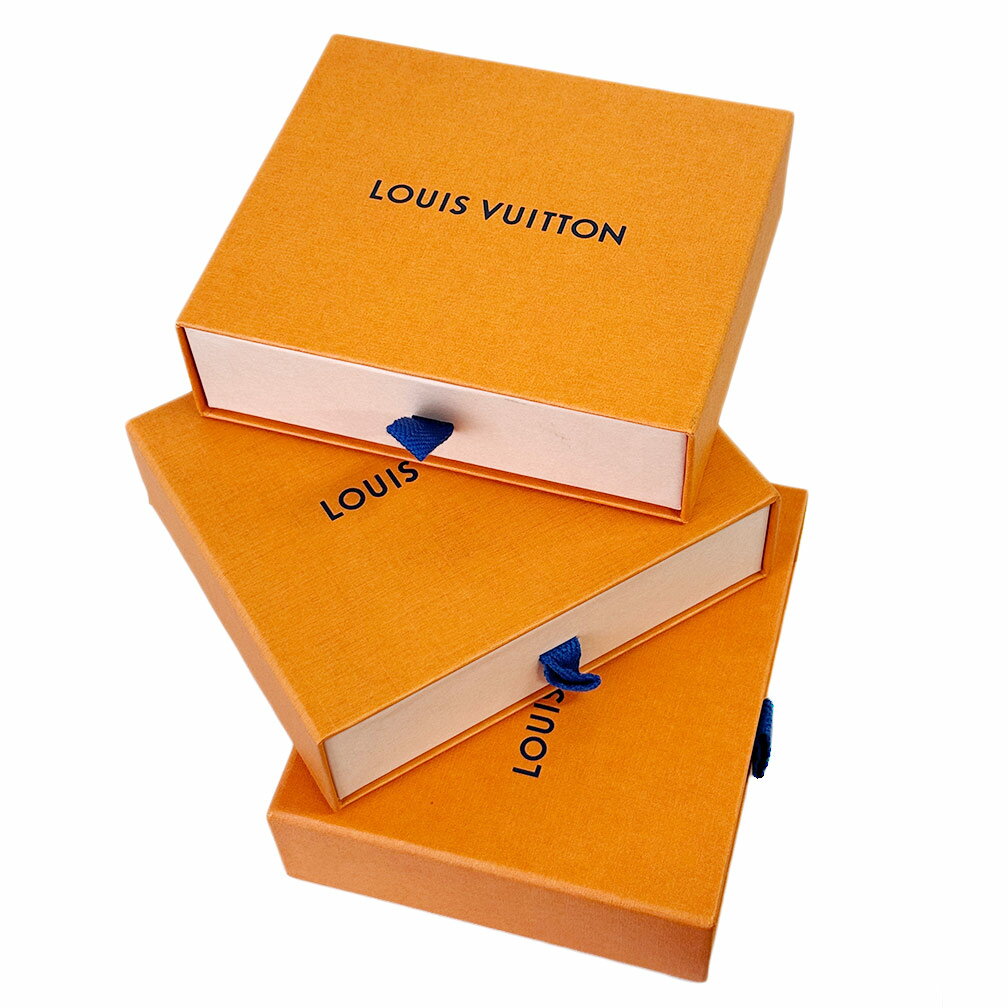 Three orange Louis Vuitton branded boxes with blue pull ribbons stacked on a white background.