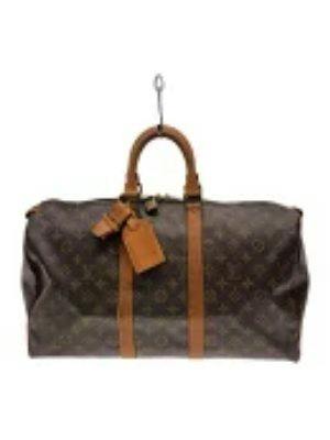 Front view of a Louis Vuitton Keepall 45 monogram canvas duffle bag with brown leather handles and luggage tag.