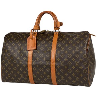 Brown Louis Vuitton キーポル 50 monogram canvas duffel bag with leather handles and luggage tag.