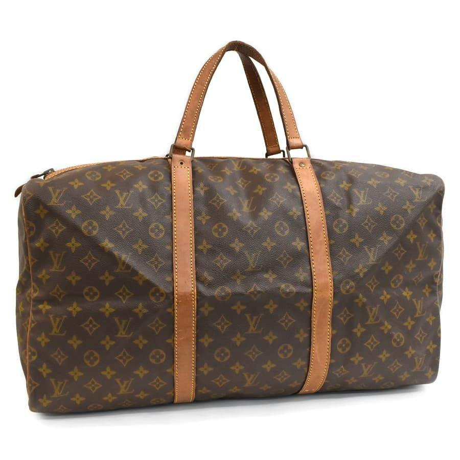 Brown Louis Vuitton monogram canvas Keepall-style duffel bag with brown leather handles and straps.