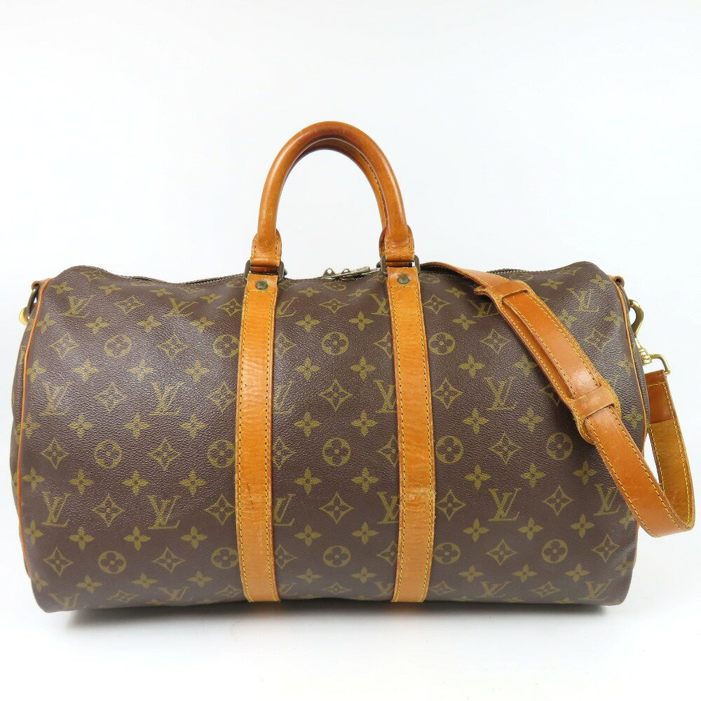 Brown Louis Vuitton Monogram duffle bag with tan leather handles, leather trim, and a shoulder strap shown on a white background.