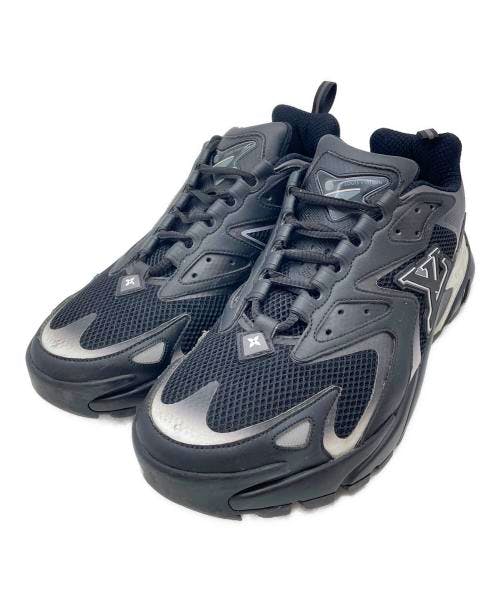 Pair of black LV Runner Tactic textile sneakers photographed on a white background from an angled top-front view.