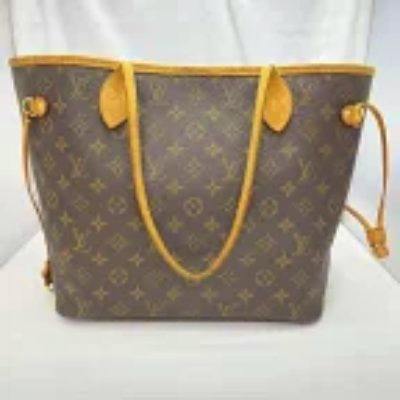 Front view of the Louis Vuitton M40156 Monogram Neverfull MM tote bag in monogram canvas with tan leather trim and shoulder straps.
