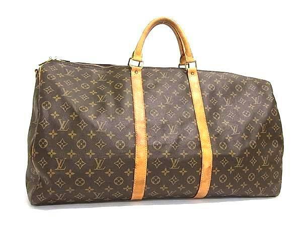 Front view of the LOUIS VUITTON Monogram Keepall 60 travel bag with brown monogram canvas and leather handles.