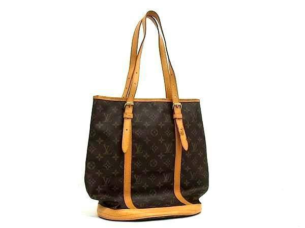 Brown Louis Vuitton monogram Bucket GM bucket-shaped tote bag with leather shoulder straps.