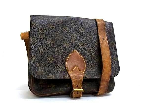 Brown Louis Vuitton Monogram Cartouchière GM crossbody shoulder bag with leather strap on a white background.