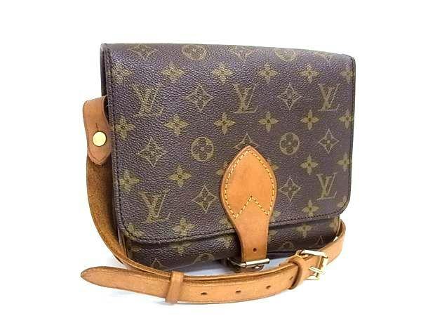 Brown Louis Vuitton monogram canvas crossbody bag with leather strap and front flap closure.