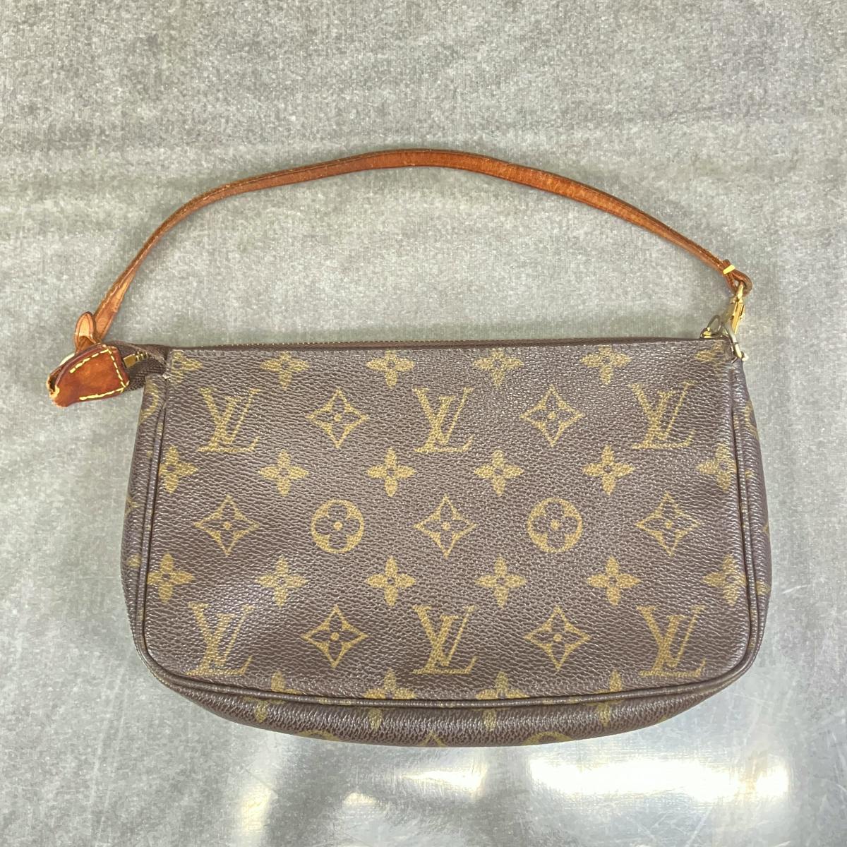 Louis Vuitton brown monogram canvas shoulder bag with a short leather strap shown flat on a gray surface.