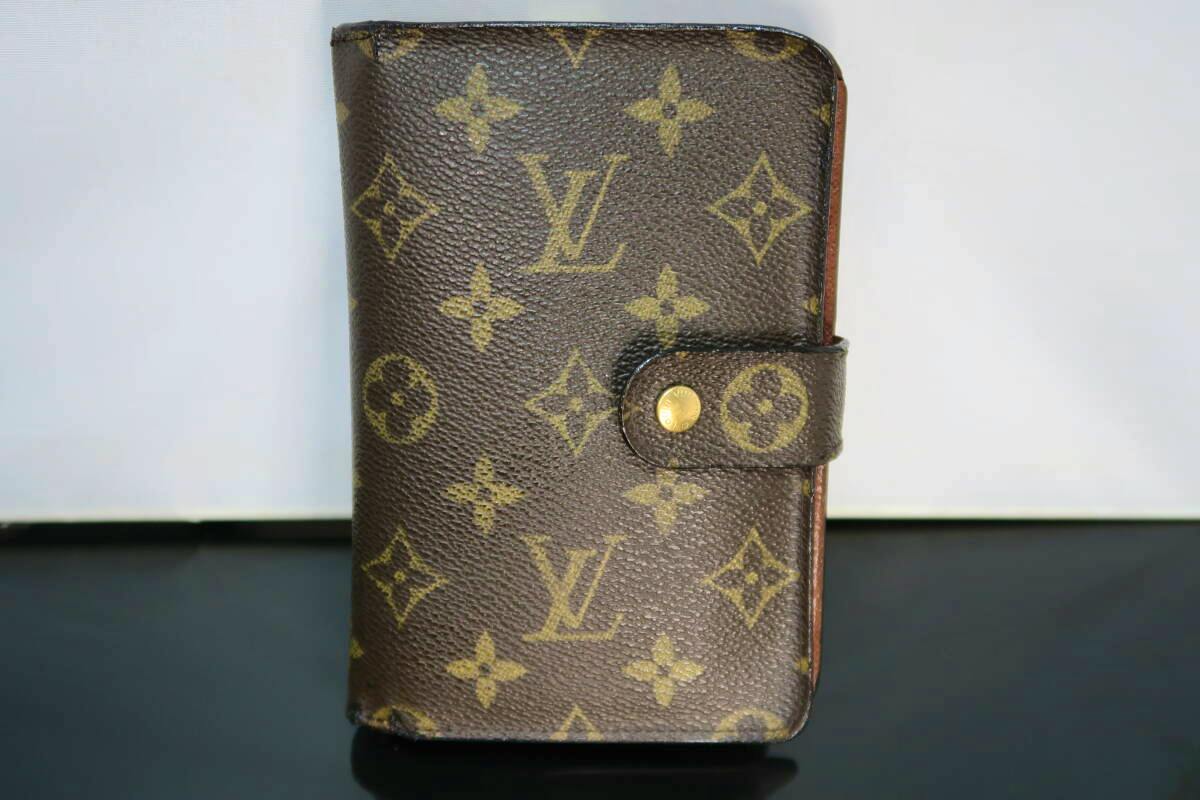 Front view of the Louis Vuitton monogram canvas large zip wallet with a snap closure.