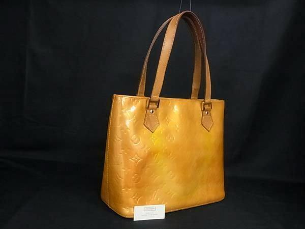 Beige Louis Vuitton Monogram Vernis Houston tote handbag shown against a black background.