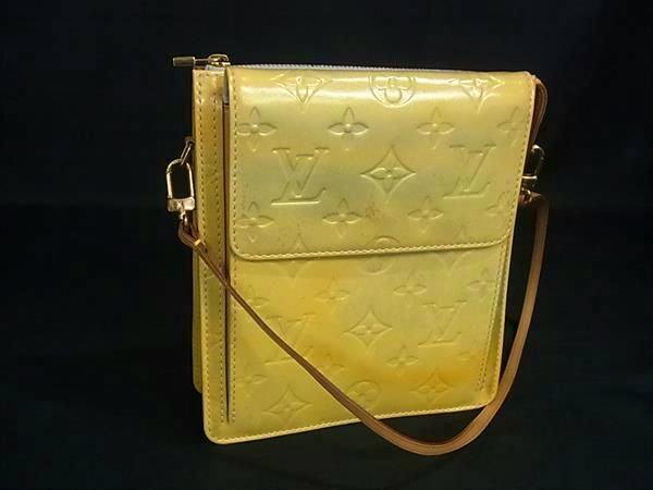 Yellow Louis Vuitton Monogram Vernis Mott shoulder mini bag with strap photographed against a black background.