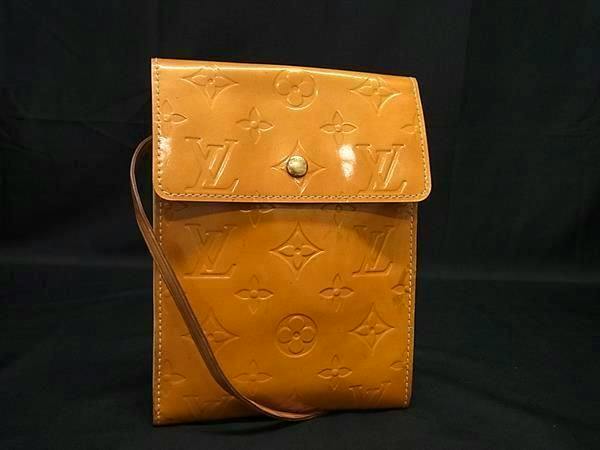 Front view of the lime-yellow Louis Vuitton Monogram Vernis Kenmare shoulder wallet with embossed monogram and flap closure.