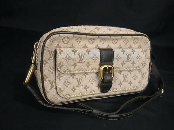 Brown Louis Vuitton Monogram Mini Juliette MM crossbody shoulder bag on a black background.