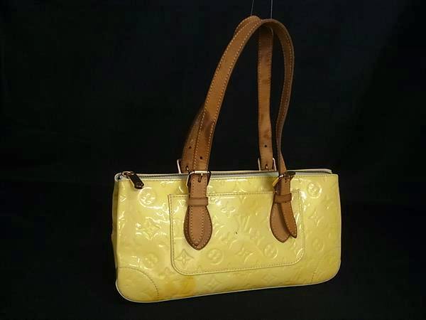 Yellow Louis Vuitton M93508 Monogram Vernis Rosewood Avenue handbag with brown shoulder straps on a black background.