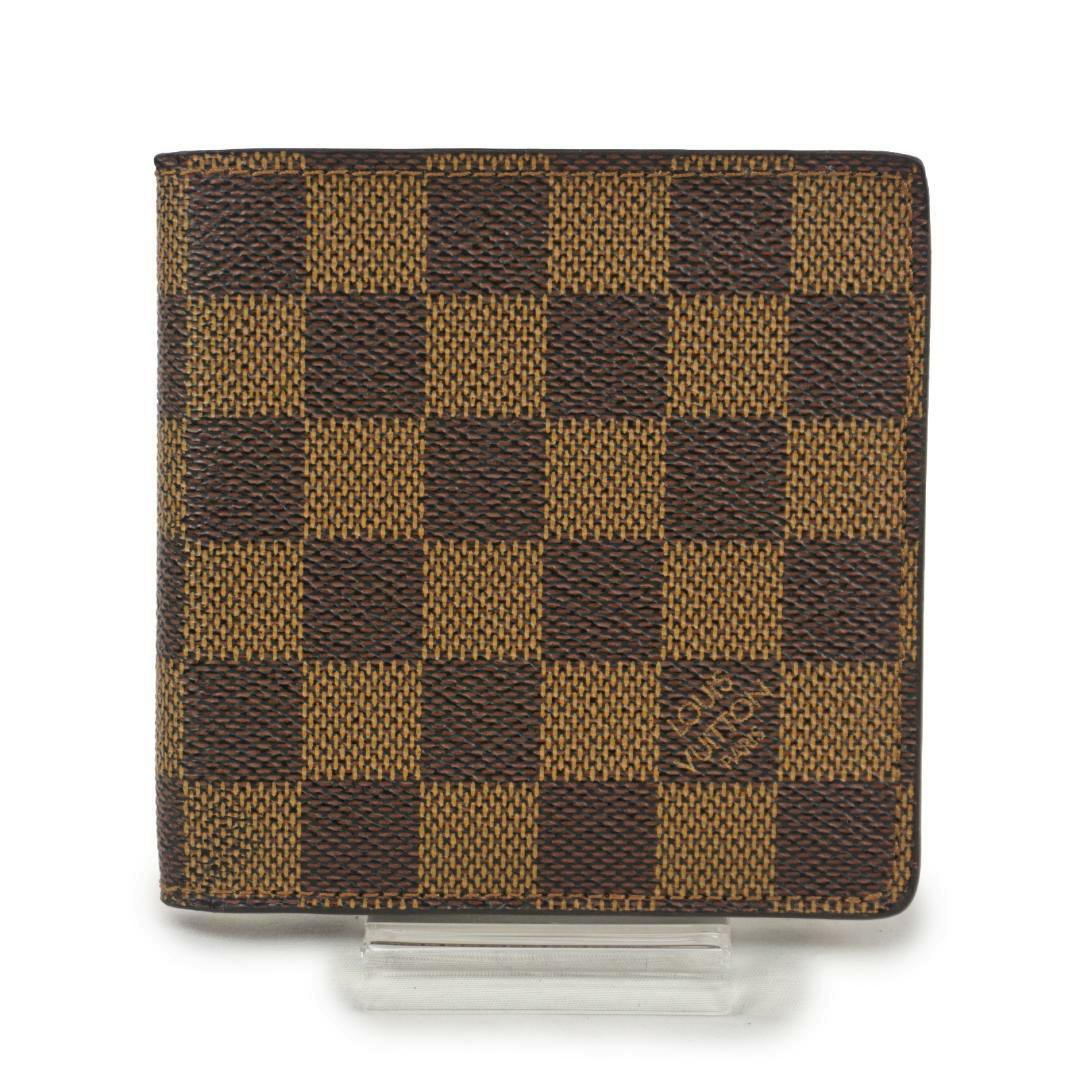 Front of the Louis Vuitton Marco wallet in Damier Ebene canvas displayed on a small clear stand.