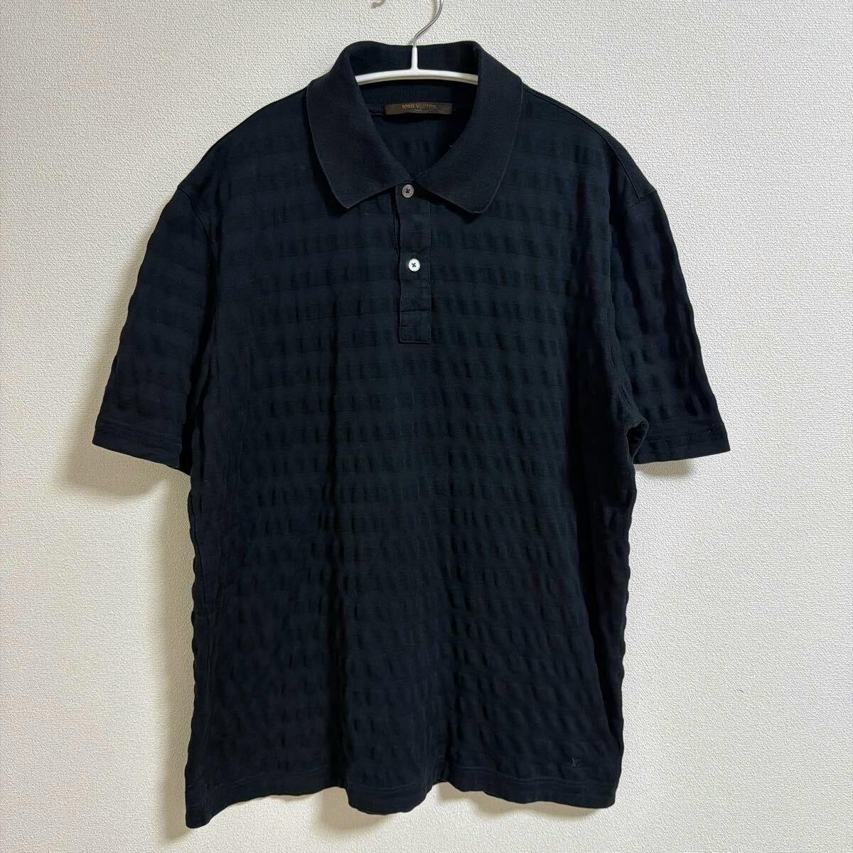 Black Louis Vuitton men's cotton polo shirt (size XL) with short sleeves and a collar hanging on a hanger against a plain wall.