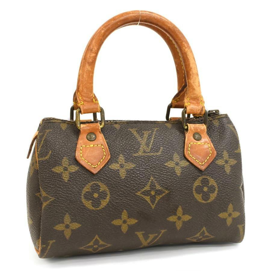 Front view of a Louis Vuitton monogram canvas Mini Speedy handbag with leather handles and brass hardware.